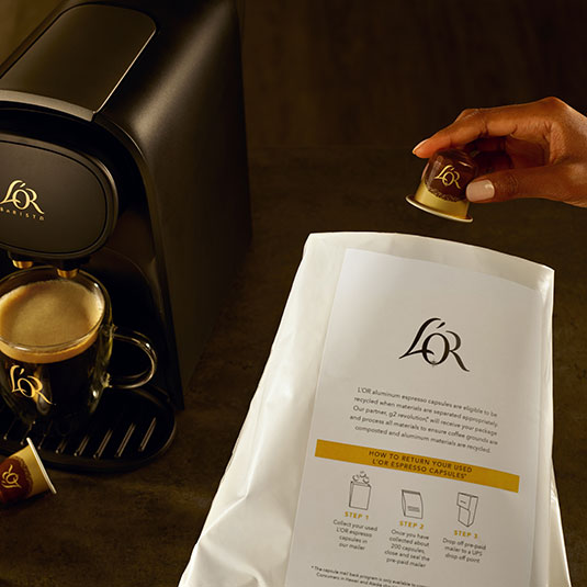 L'OR capsule being placed in recycling bag by customer at home