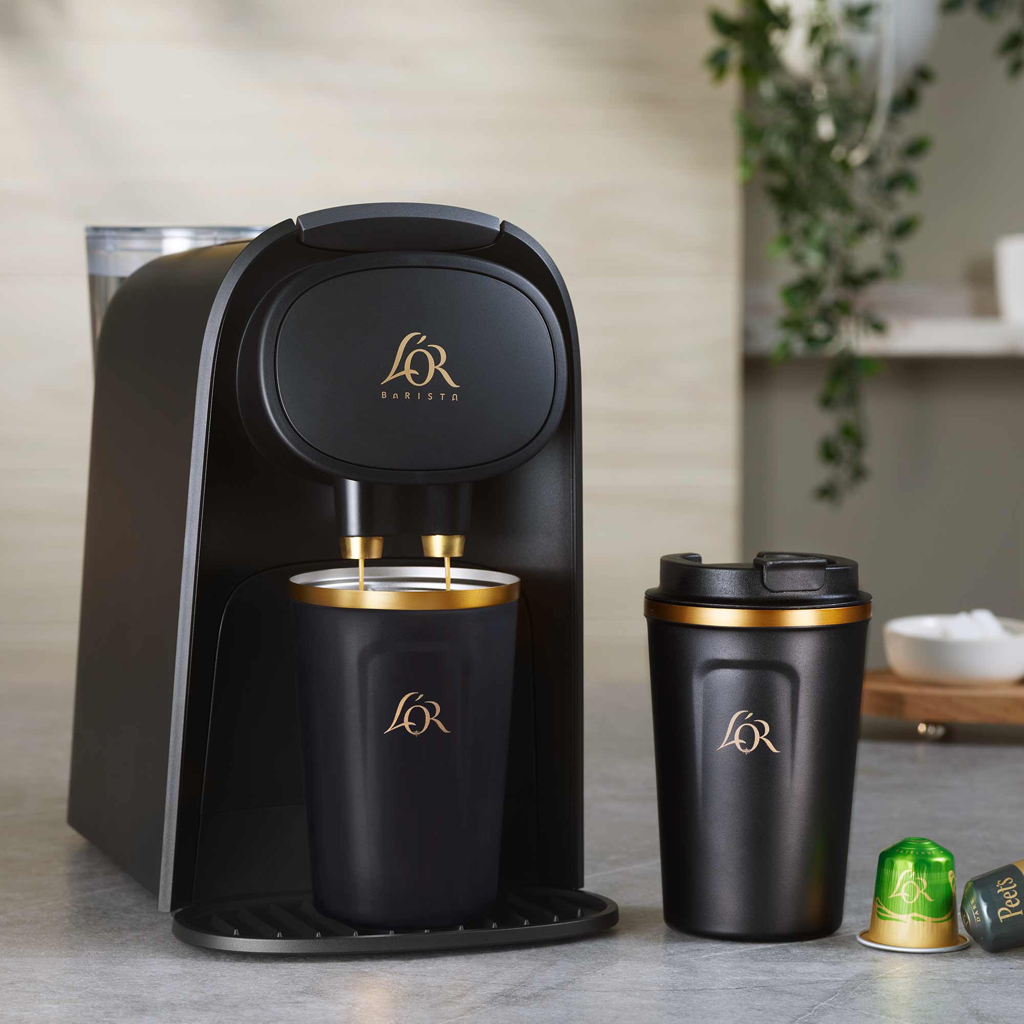 Image of L'OR Barista next to L'OR Travel Mug